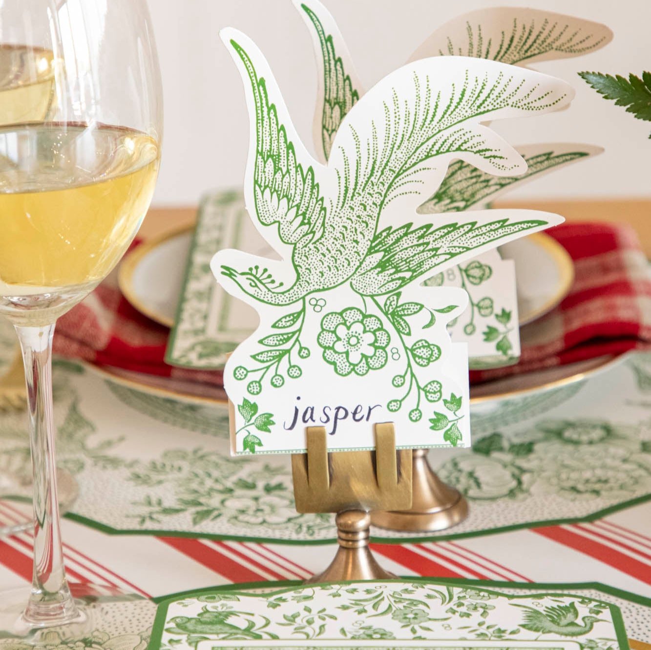 An elegant table setting with the Green Asiatic Pheasants Place Card with &quot;jasper&quot; written on it it, in a Brass Place Card holder.