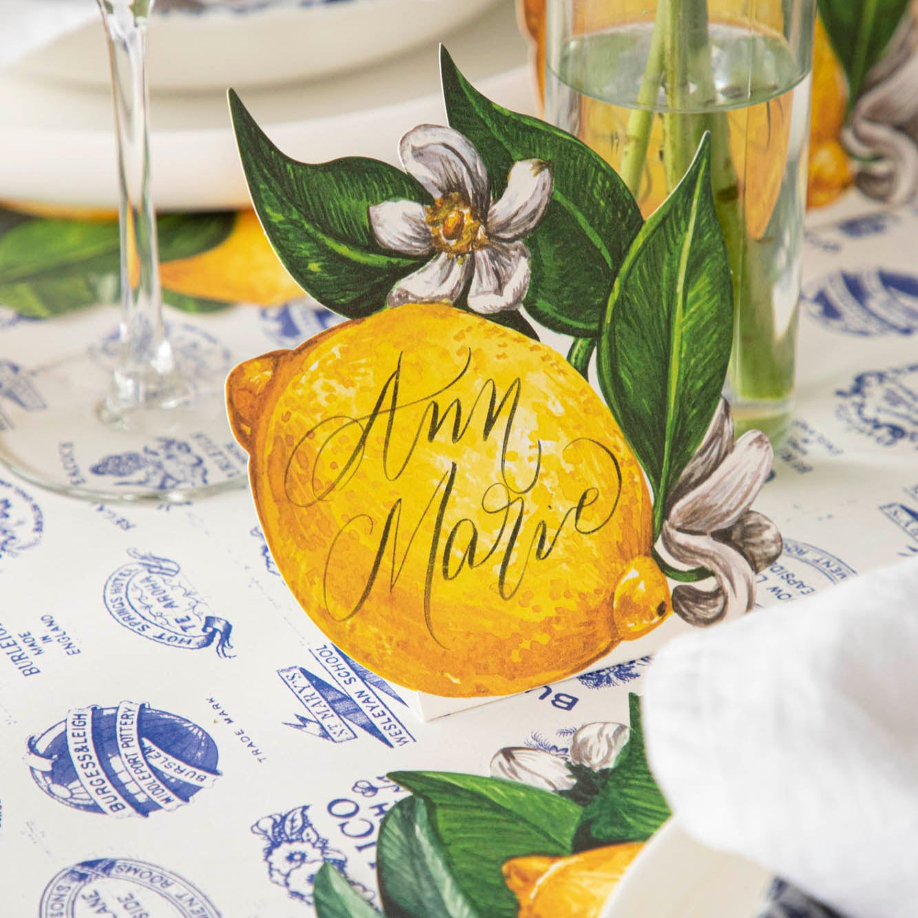 Lemon Place Card with &quot;Ann Marie&quot; written on it, behind a place setting.