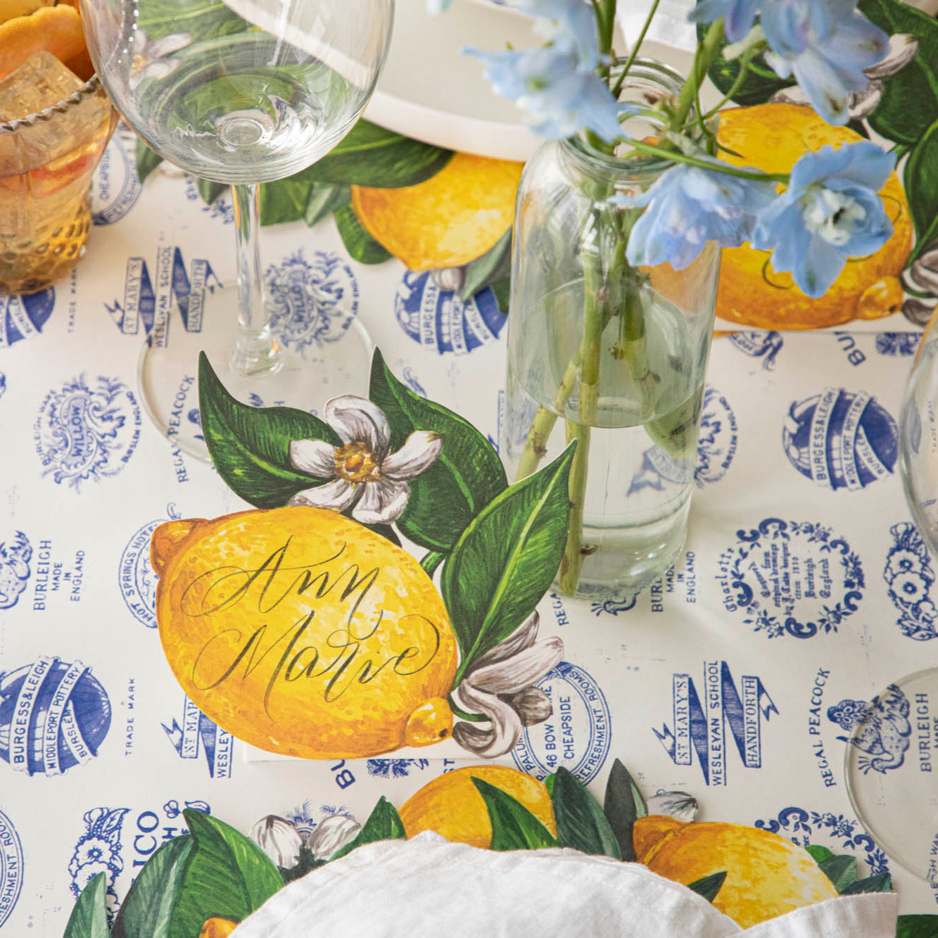 Lemon Place Card with &quot;Ann Marie&quot; written on it, behind a place setting for one.
