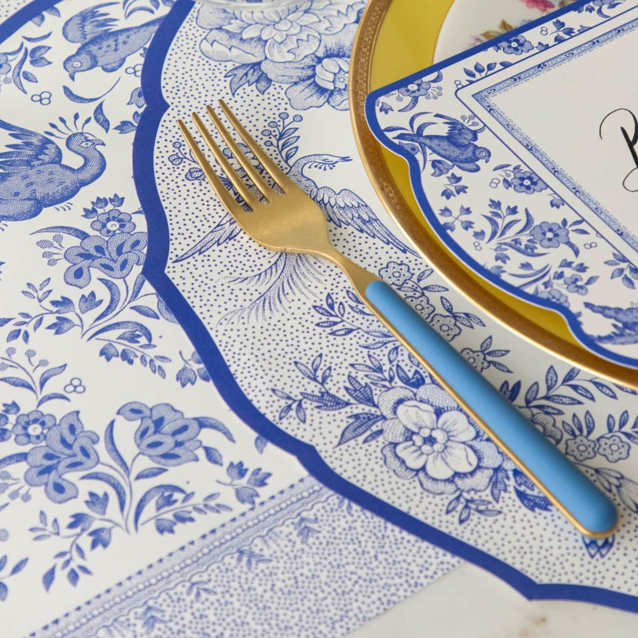 Close-up of the Blue Regal Peacock Runner under an elegant place setting, showing the intricate design in detail.
