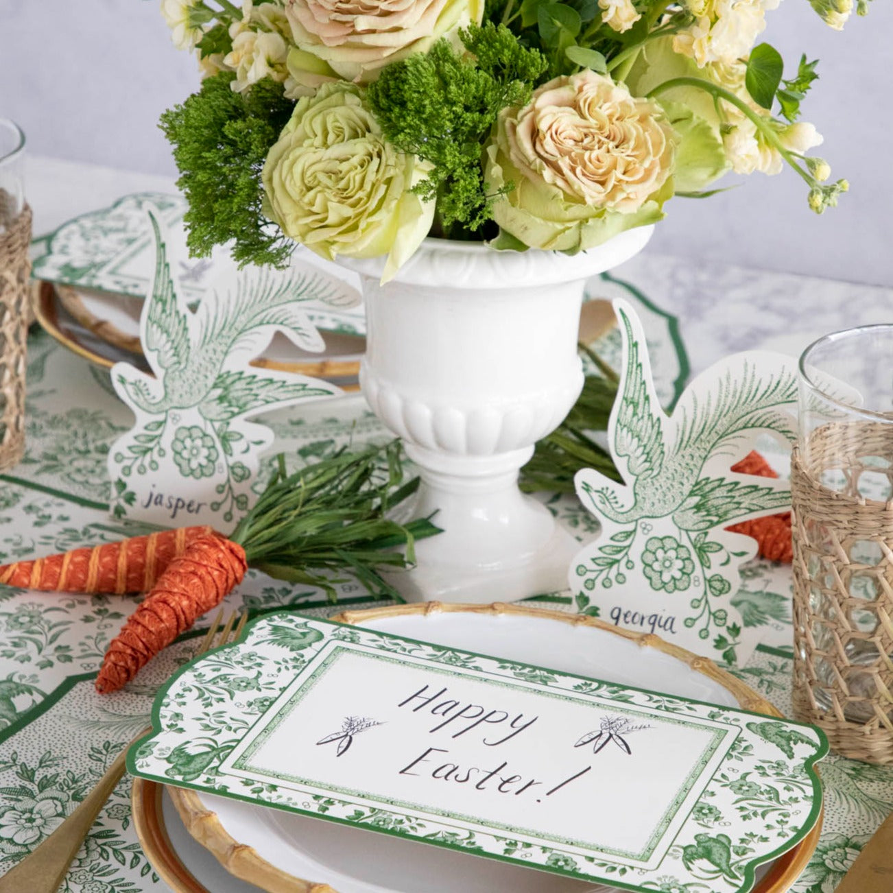 An Easter table setting with flowers, Green Asiatic Pheasants place cards by Hester &amp; Cook, and a bunny to make guests feel invited.