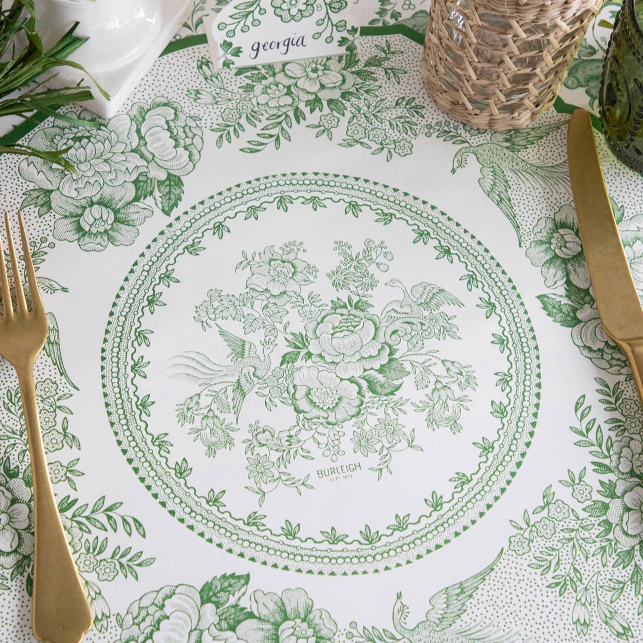 Close-up of the Die-cut Green Asiatic Pheasants Placemat in an elegant place setting, showing the artwork in detail.