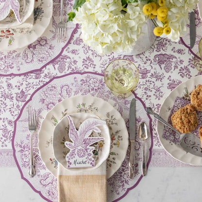 A purple and white tablescape with Die-cut Lilac Asiatic Pheasants Placemats from Hester &amp; Cook and cupcakes.