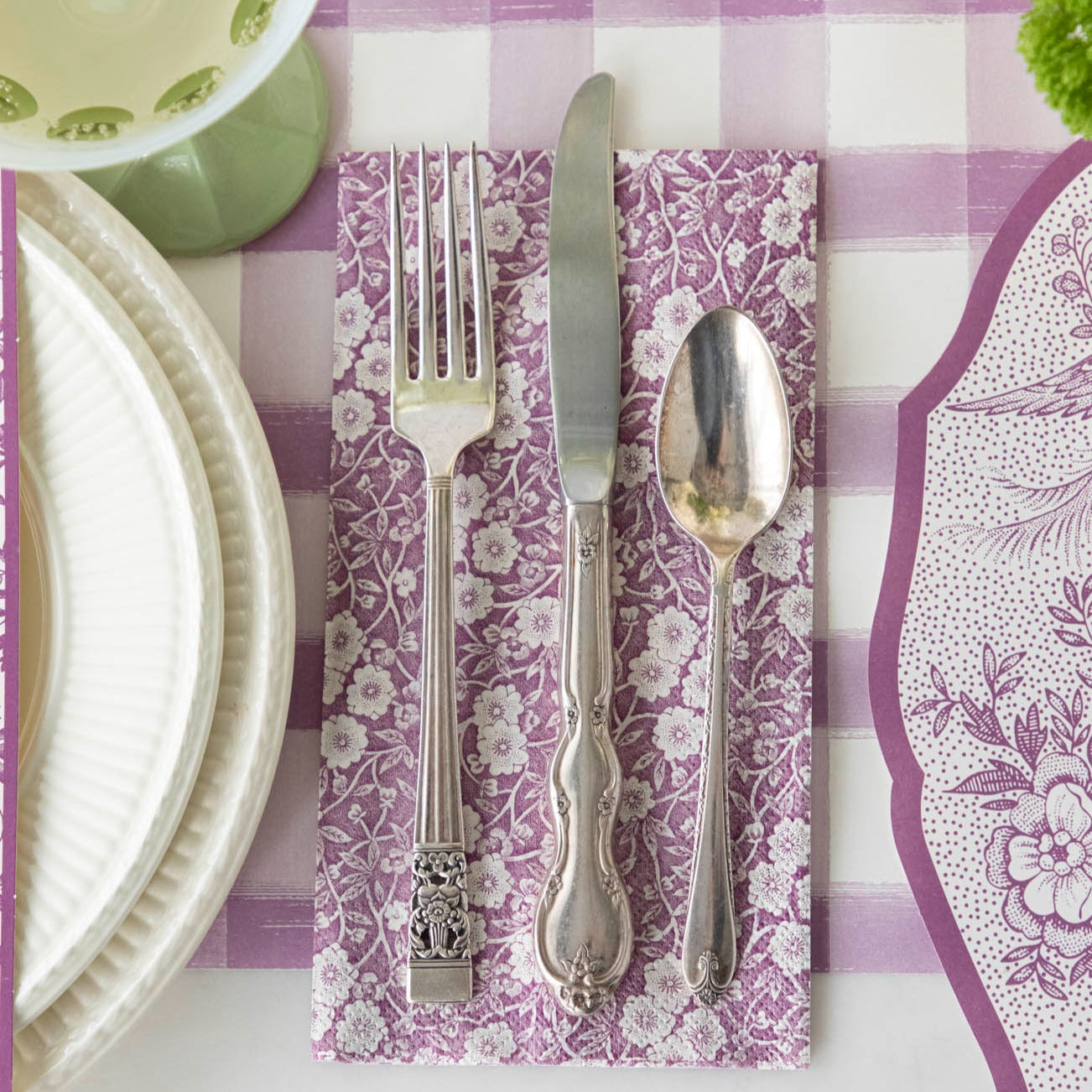 An exquisitely decorated Lilac Calico Napkins and white checkered table setting with beautiful silverware and utensils from Hester &amp; Cook.