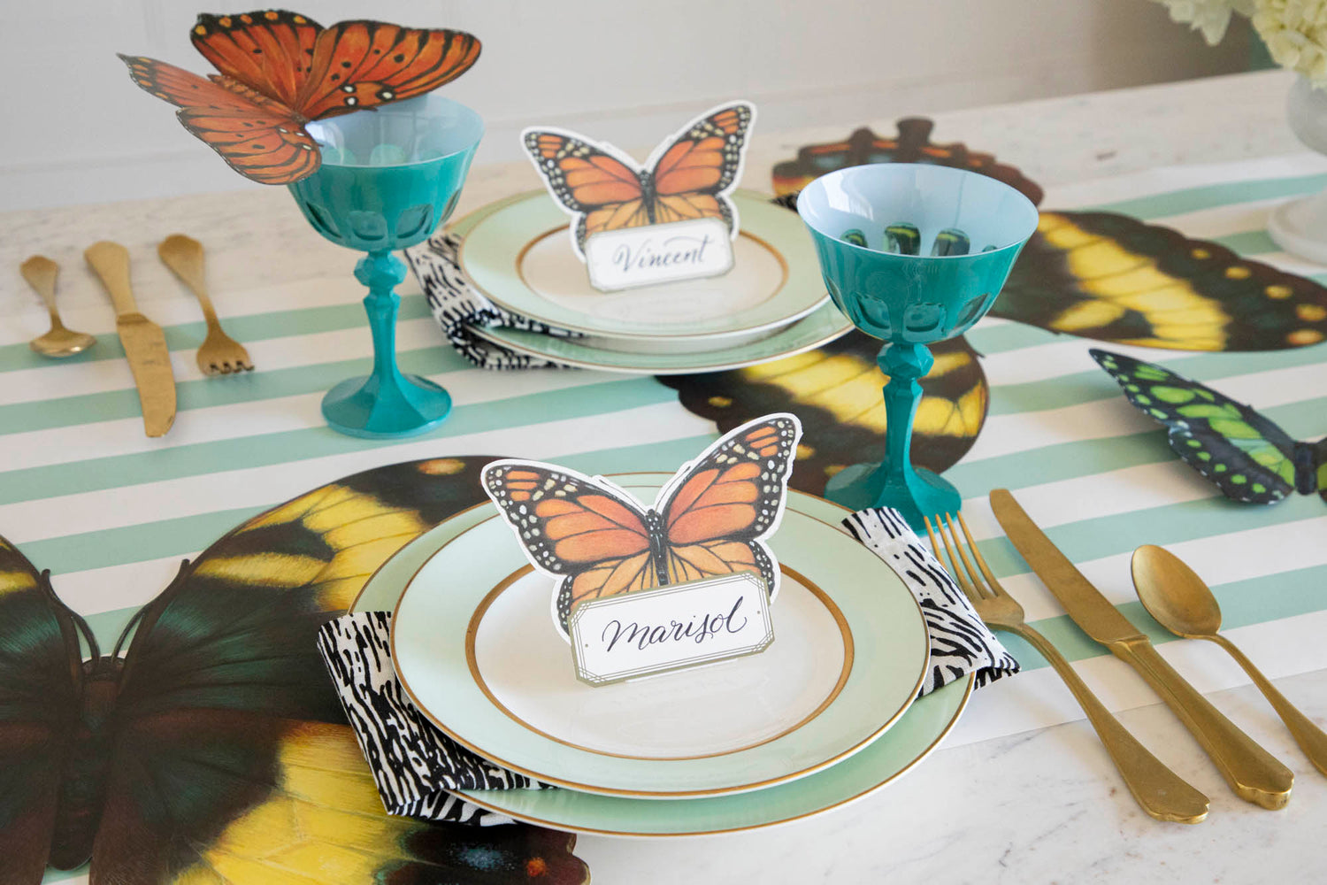 An elegant butterfly-themed table setting featuring Die-cut Butterfly Placemats at each place. 