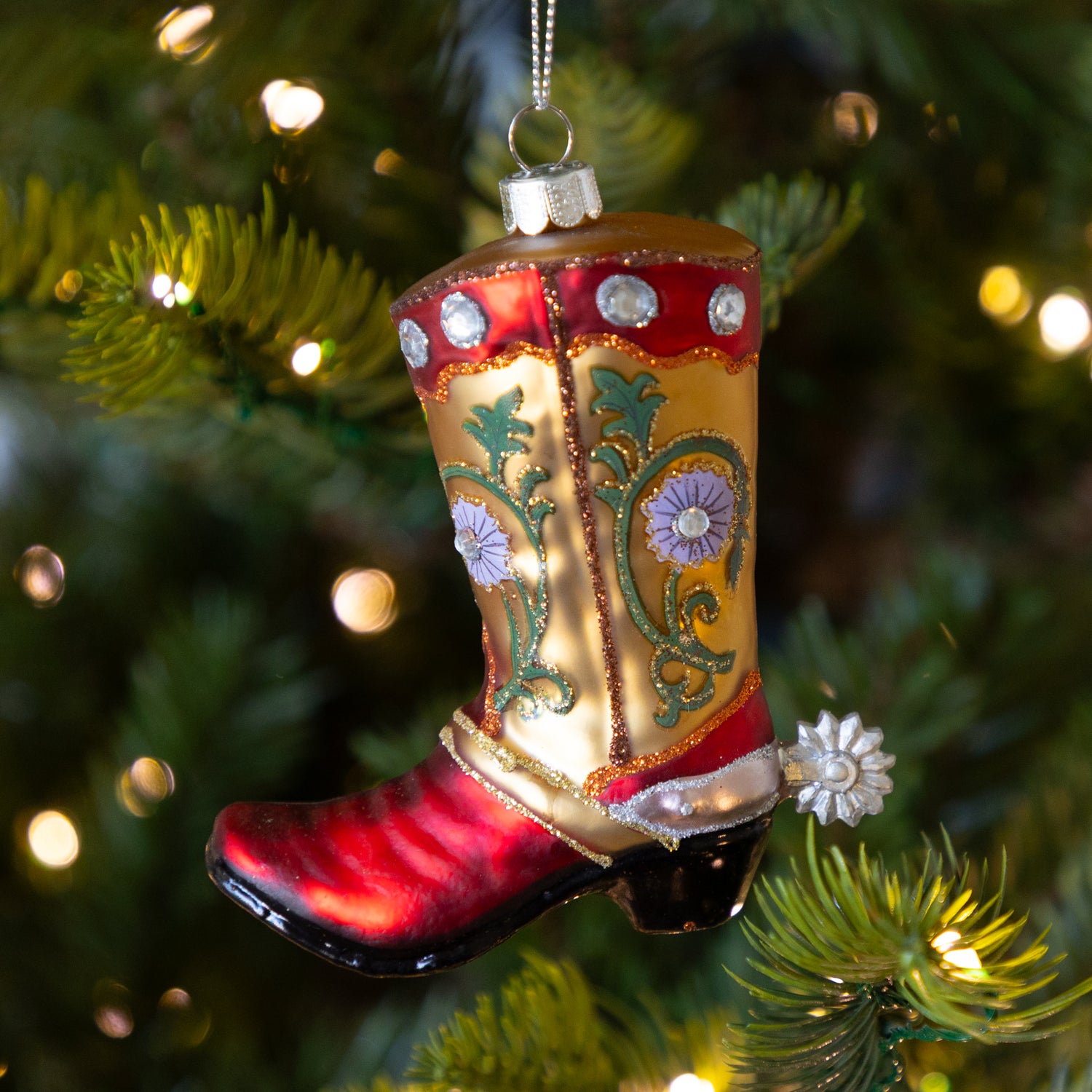 Decorative cowboy boot ornament on a Christmas tree.