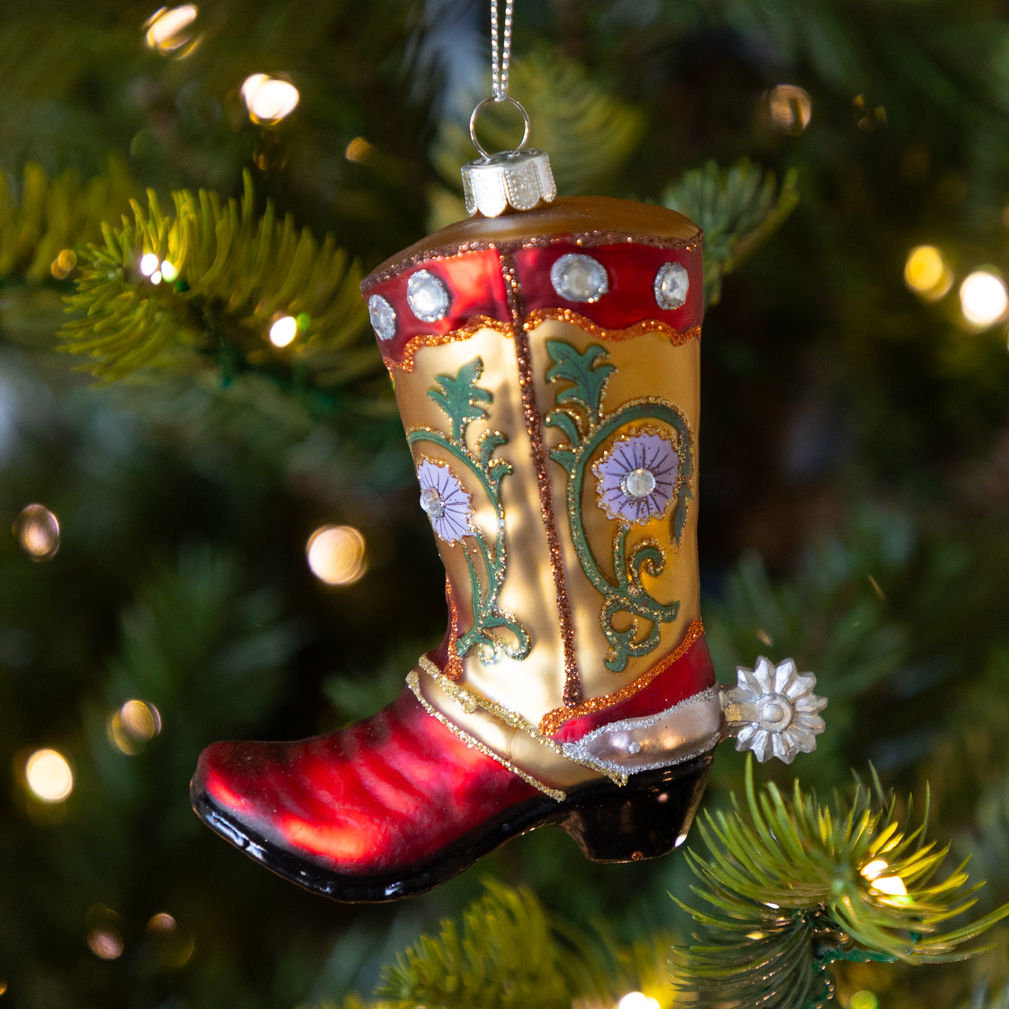 Decorative cowboy boot ornament on a Christmas tree.