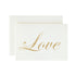 A white card with "Love" written in a beautiful script in solid gold leaf.