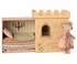 Castle toy with bedding and a mouse doll in a dress on a white background.