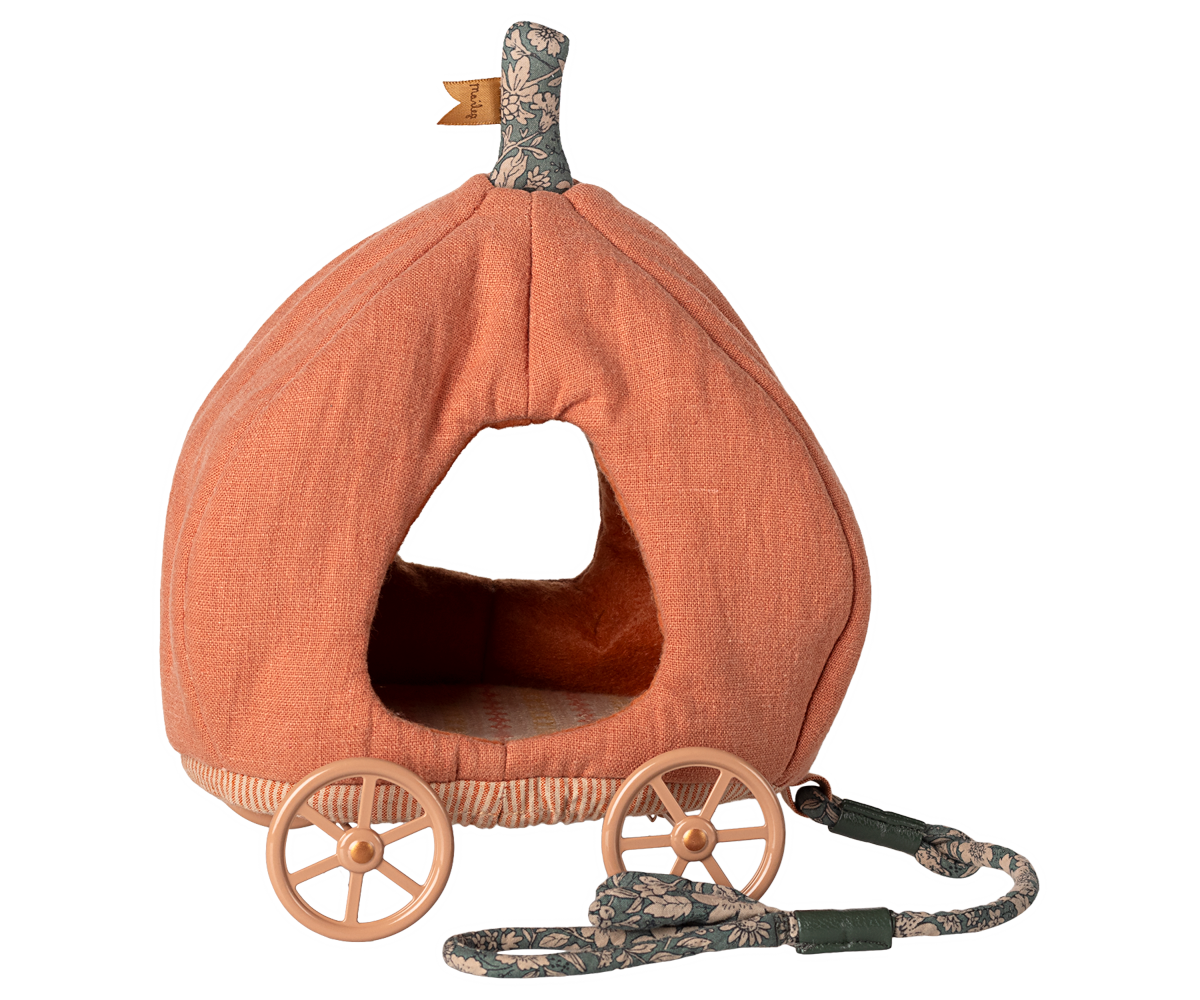 Pumpkin-shaped kids toy with wheels and a handle on a white background.