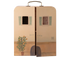 Cardboard box designed to resemble a house with windows and a plant, featuring the brand &