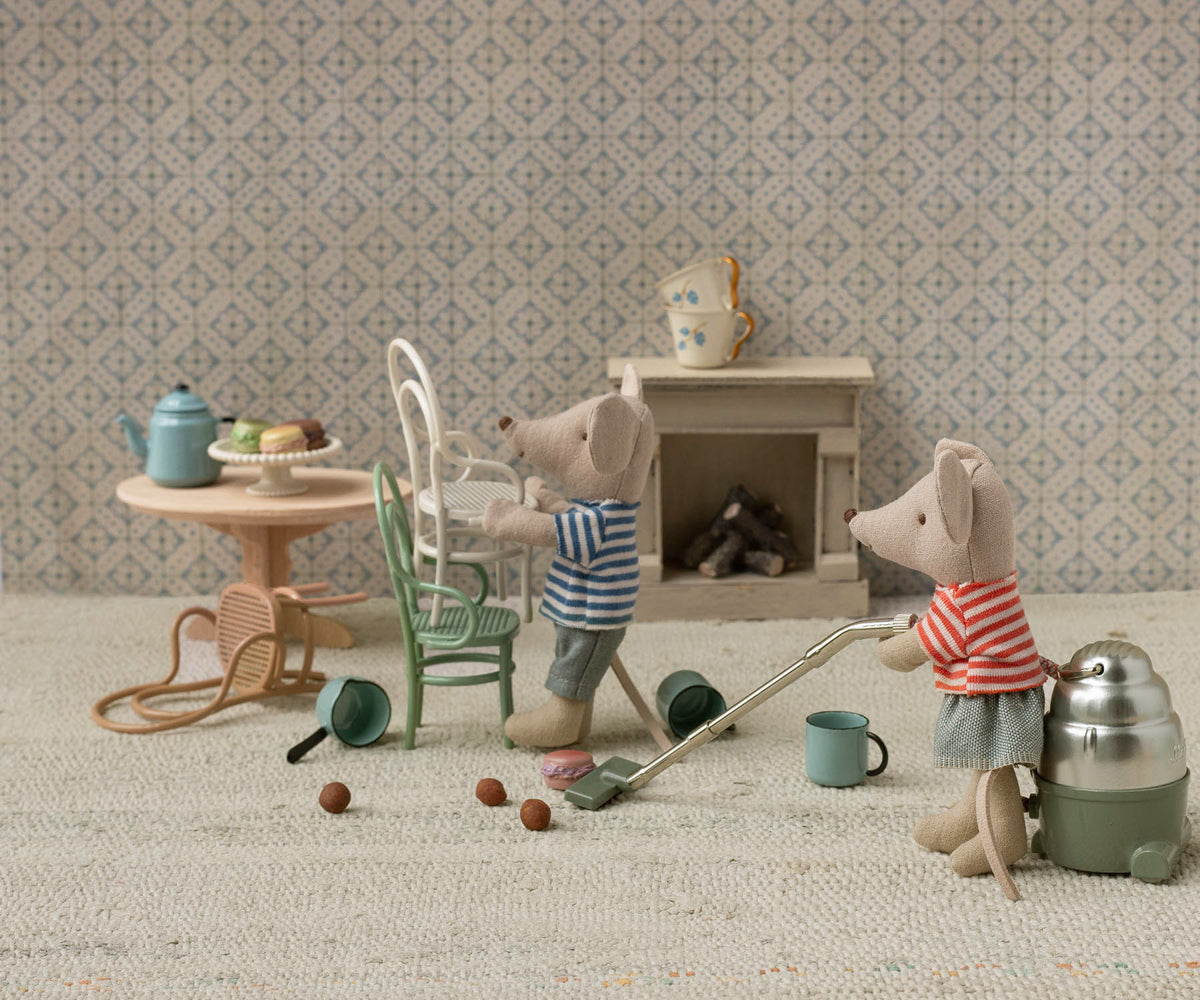 Miniature mouse figures in a living room setting with furniture and accessories.