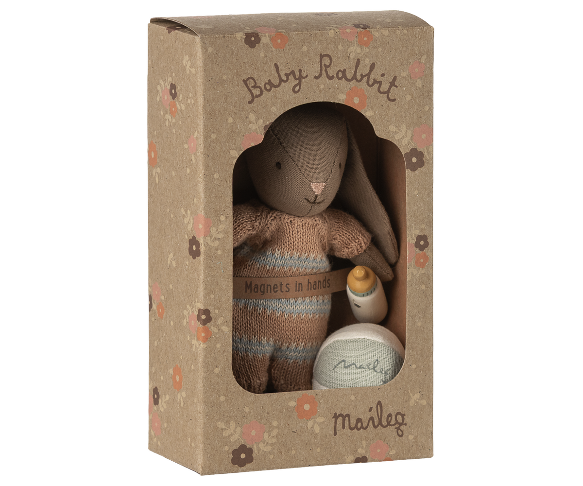 Stuffed toy rabbit in a cardboard box with &