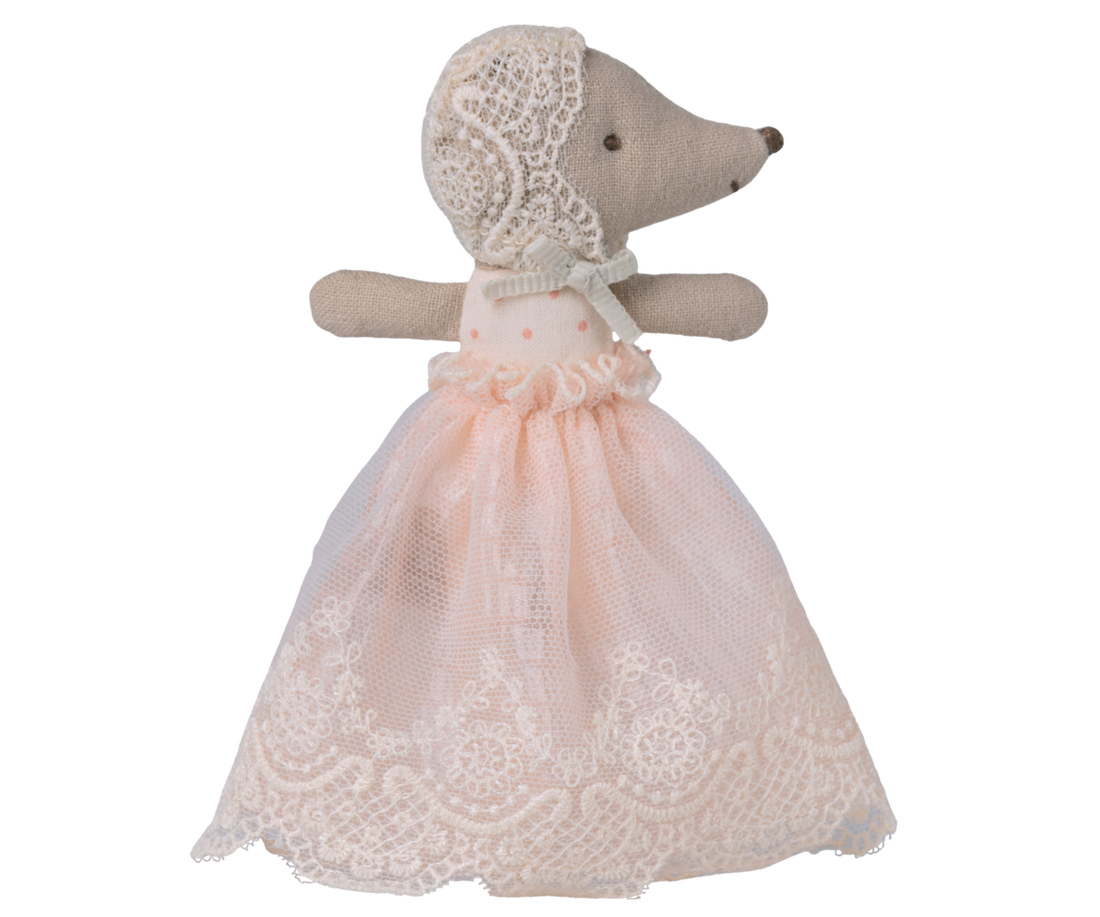Stuffed animal toy with a lace dress on a white background