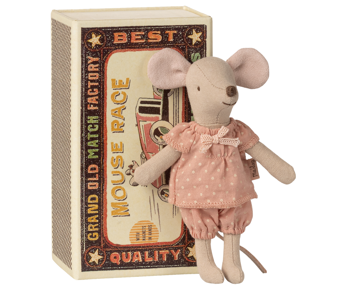 Stuffed mouse toy in a pink outfit standing next to a matchbox with decorative text.