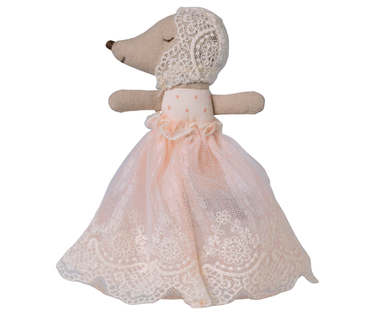 Stuffed animal toy with a lace dress on a white background