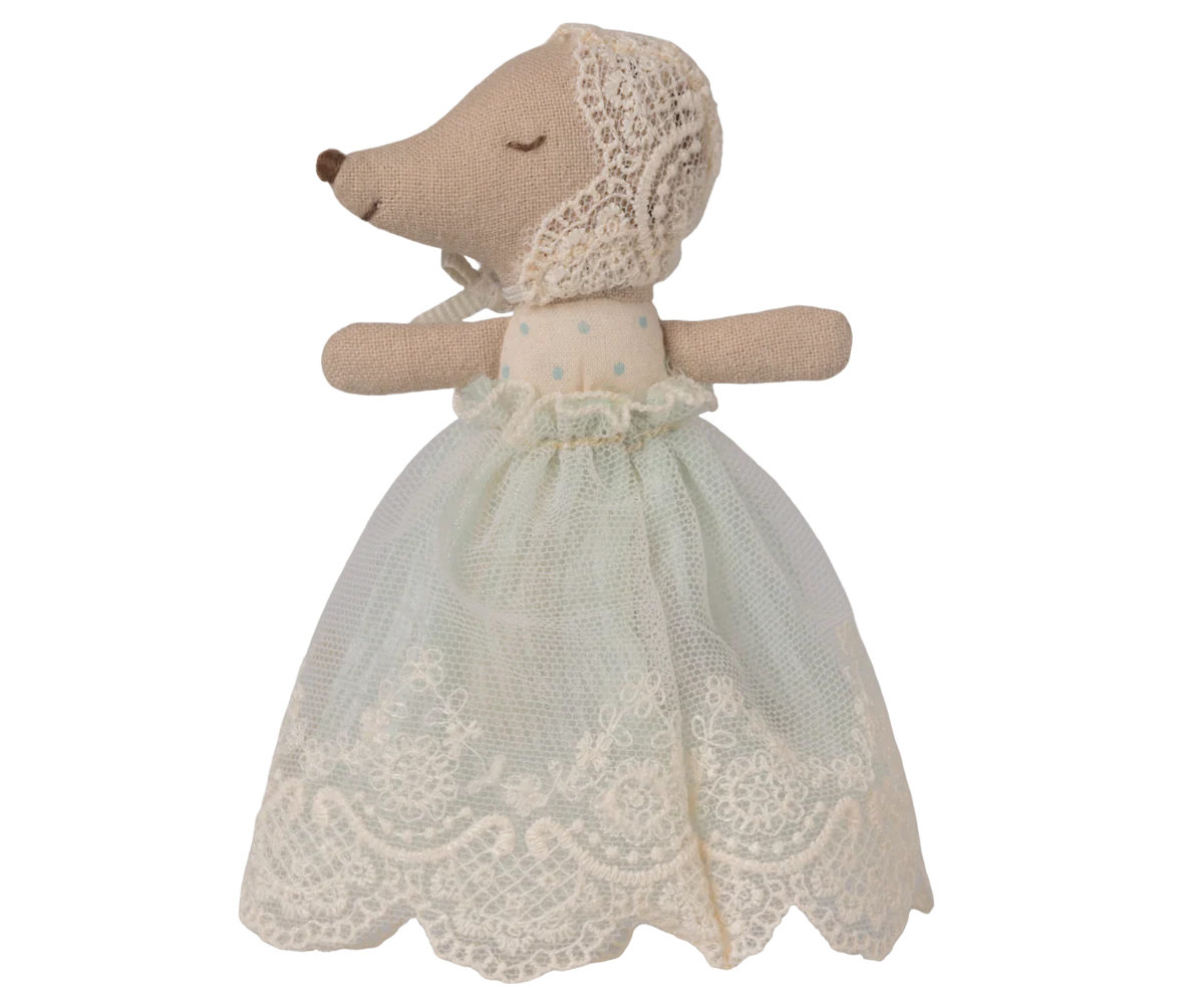 Stuffed animal toy with a lace dress on a white background