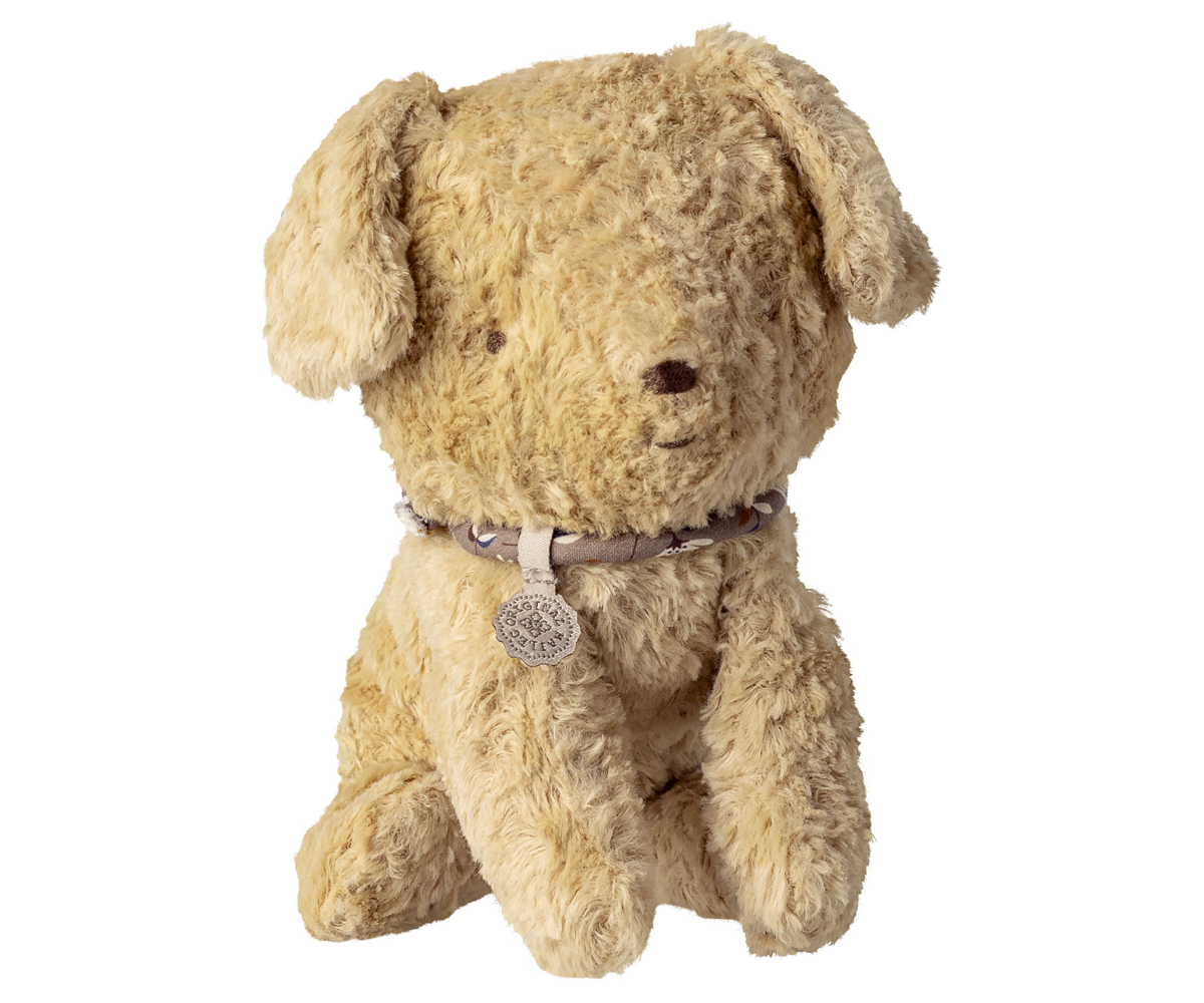 Beige plush puppy with a collar on a white background.