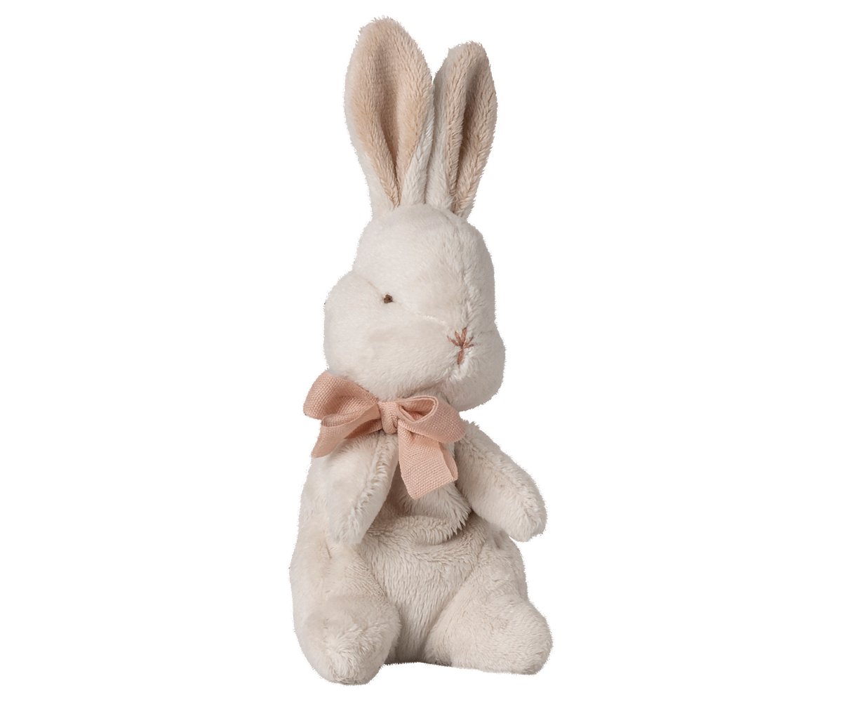 Stuffed rabbit toy with a pink bow on a white background.
