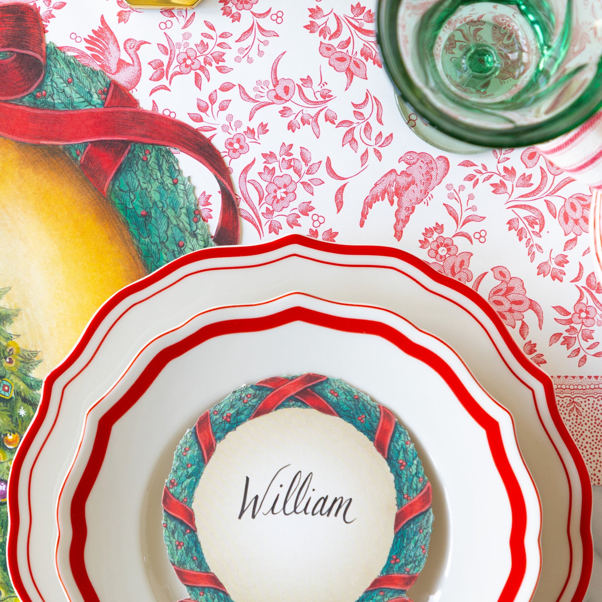 A place setting with the Red Icing on the Cake plates on the Red Regal Peacock Runner.