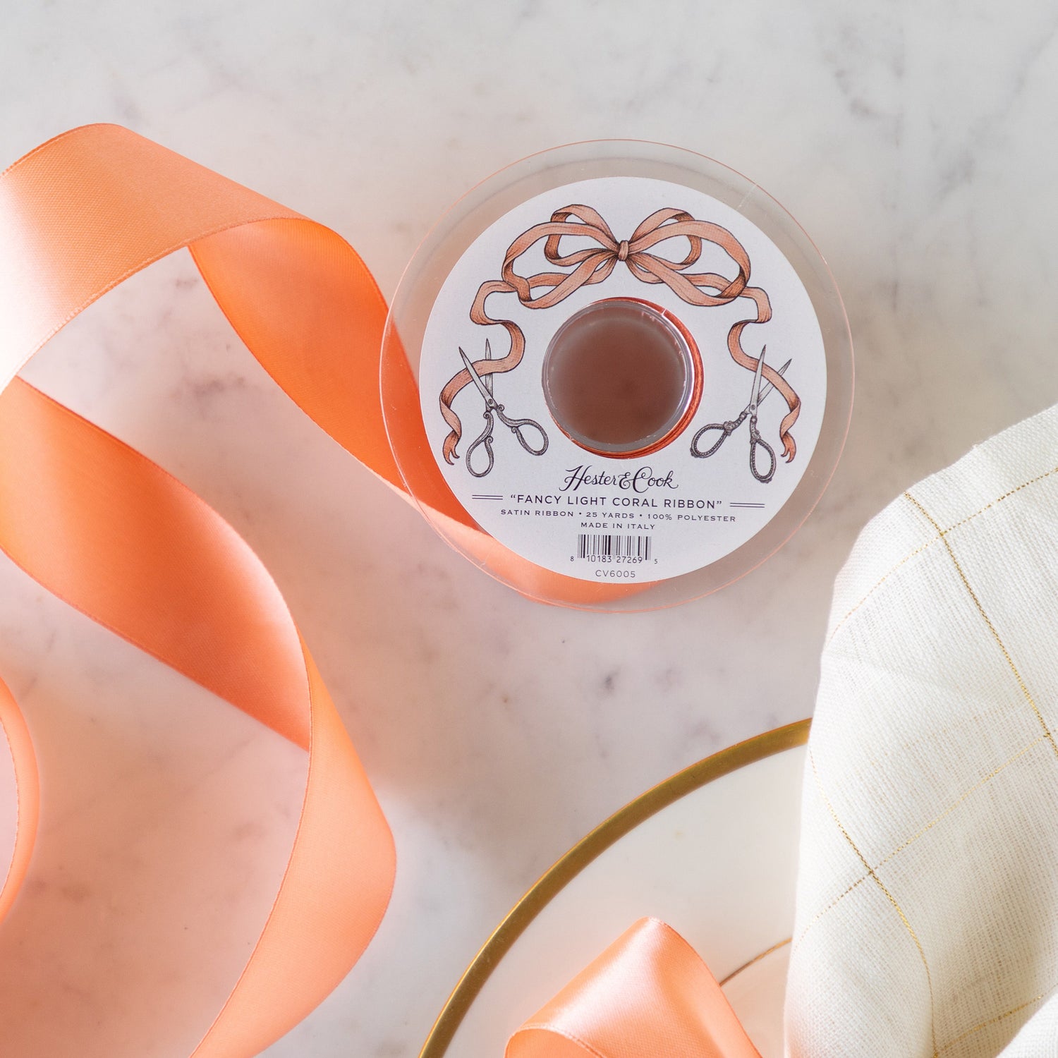 A spool of the Fancy Light Coral Ribbon unrolled.
