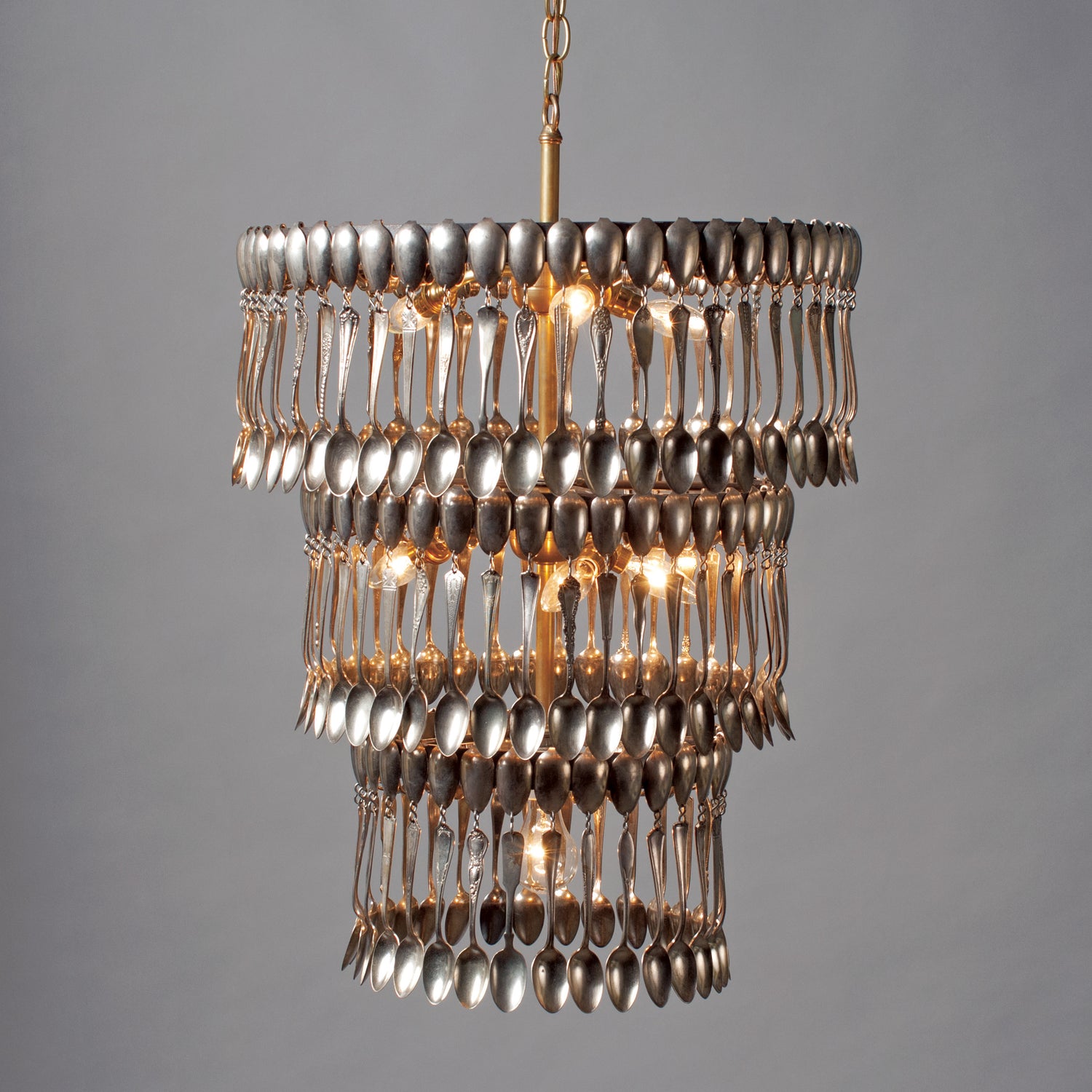 Triple Tier Spoondelier, a chandelier made of silver spoons, on a gray background, made by Hester &amp; Cook.