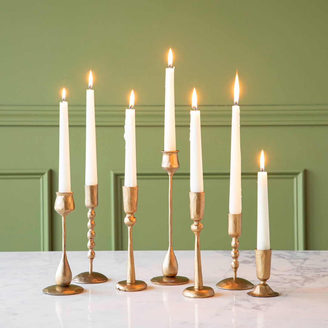 Group of assorted brass candleholders by Creative Co-Op. 