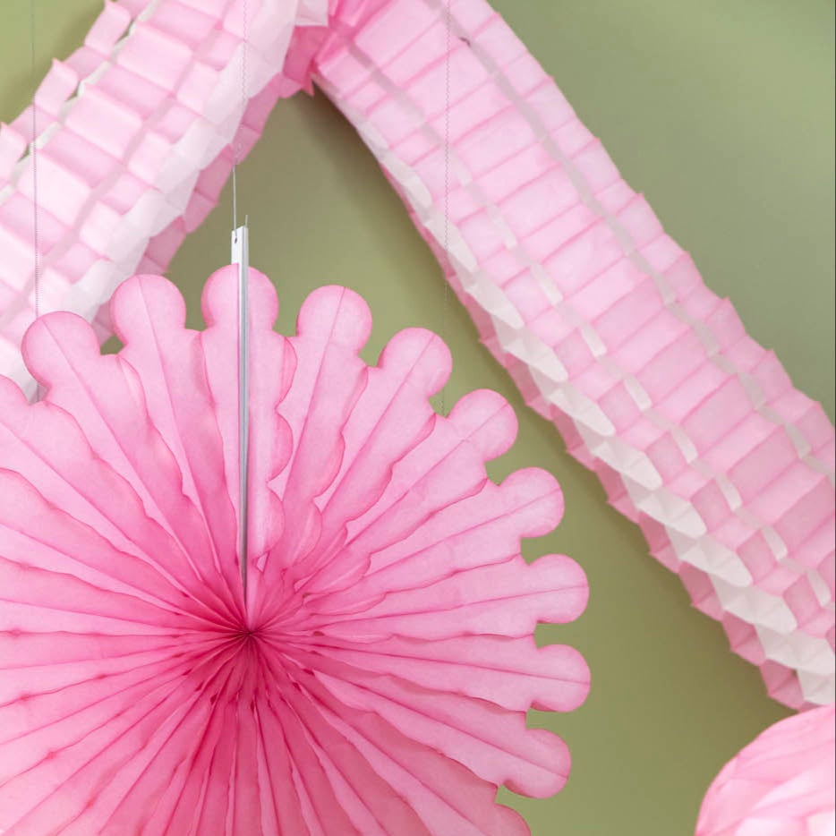 Honeycomb Celebration Garland strung on a wall.