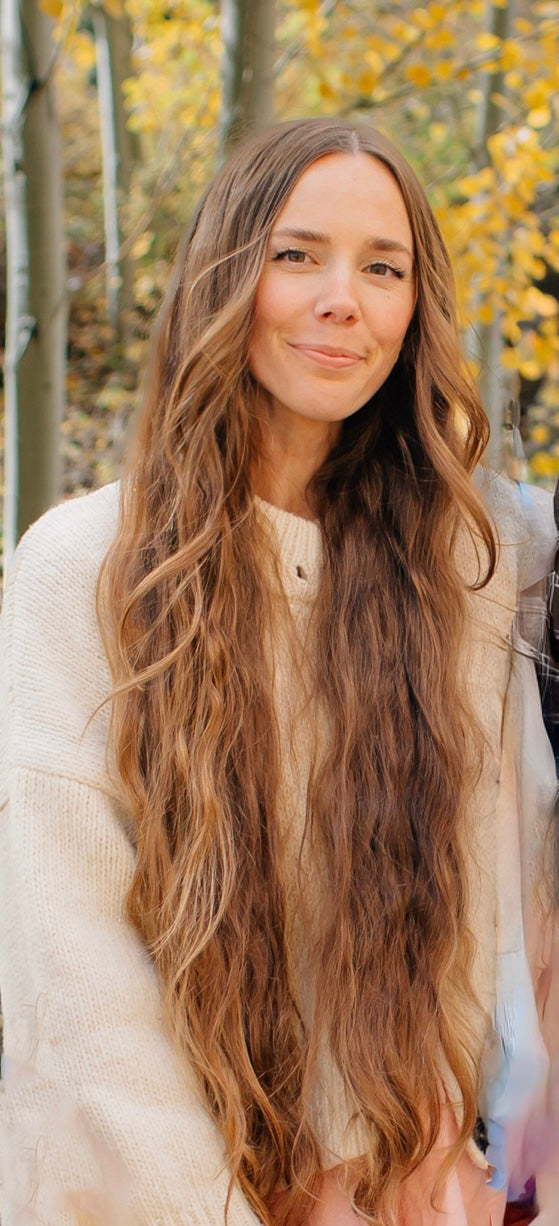 Artist, Celeste Clark, posing outdoors.