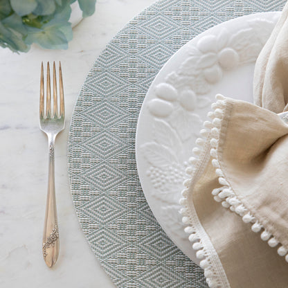 Boxwood Round Placemat with place setting on it