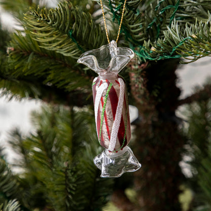 Long Red Plaid Candy Shaped ornament hanging in a tree