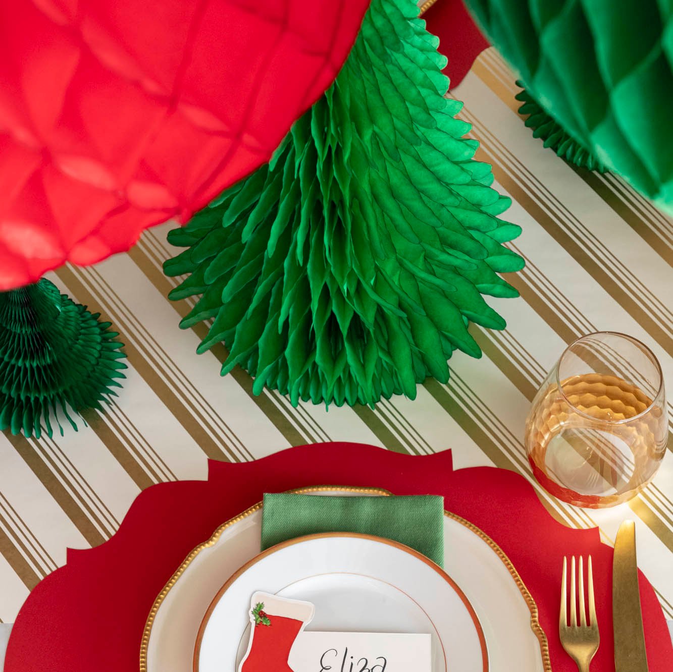 A topdown view of the medium honeycomb tree, behind a Christmas themed place setting.