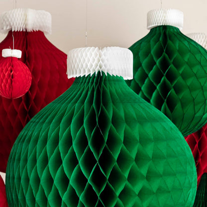 A close up view of the green, Honeycomb Large Classic Ornament in front of various sized honeycomb ornaments.