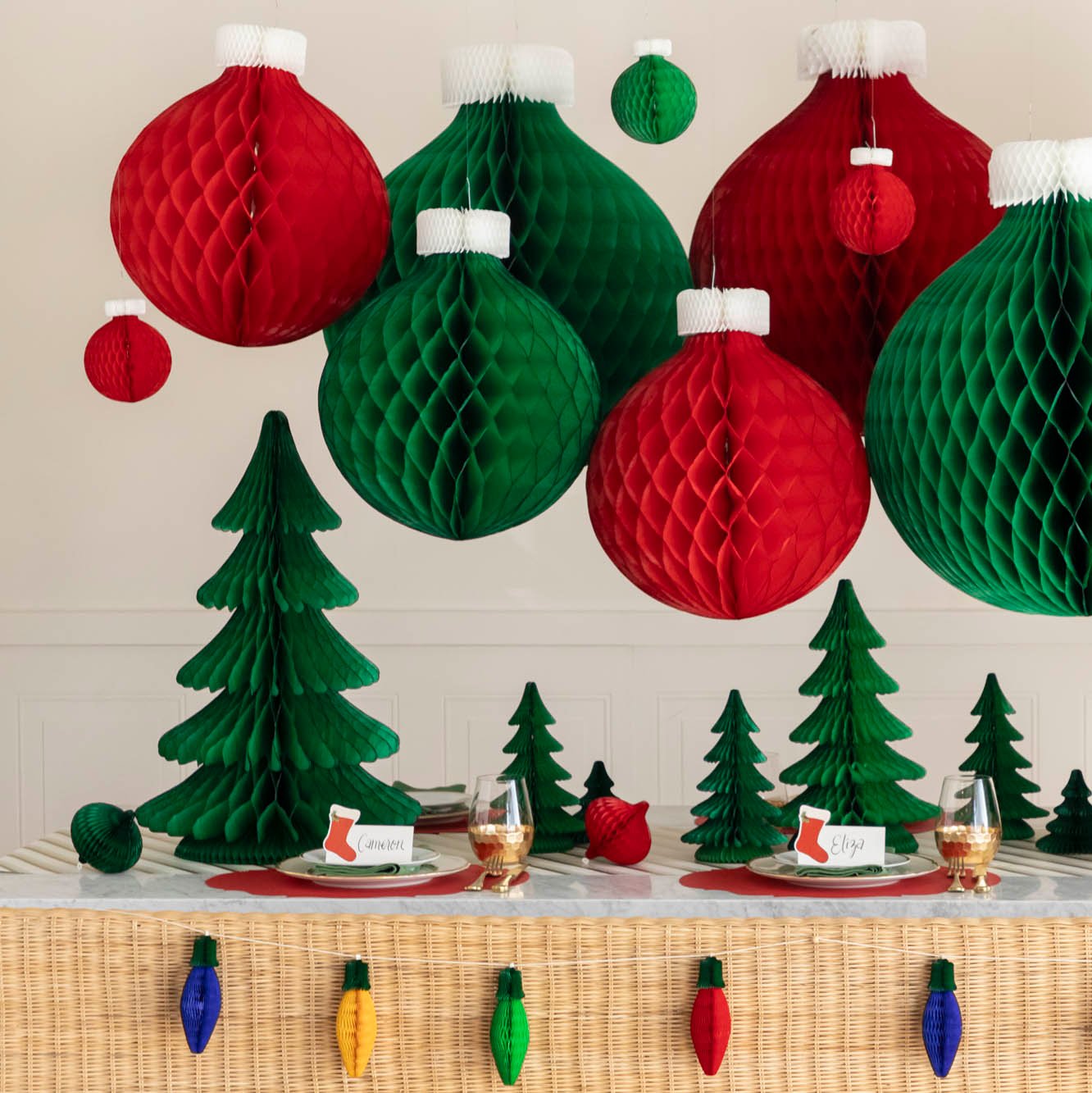 A festive Christmas table setting with honeycomb ornaments hanging and scattered honeycomb trees on the table.