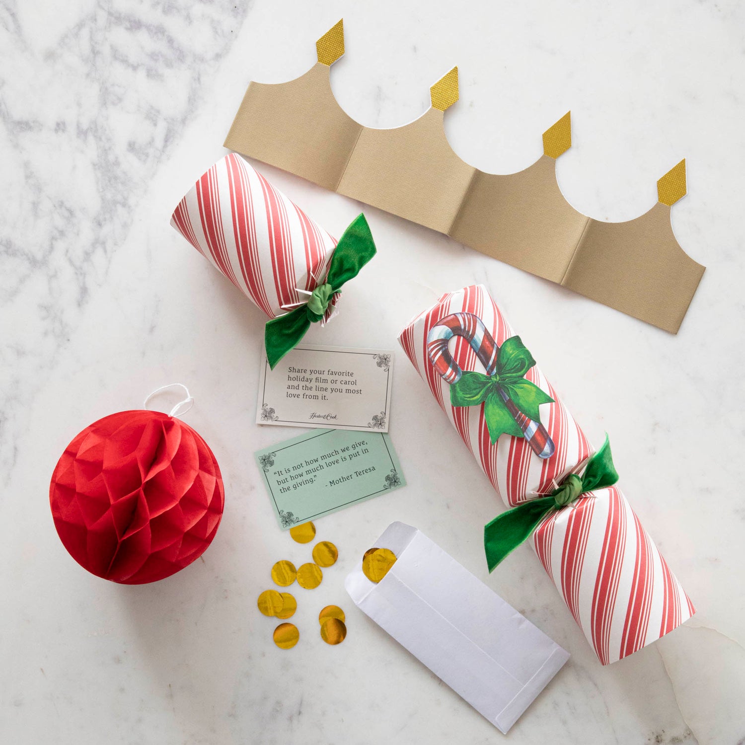 The Candy Cane Cracker containing a festive honeycomb ball, a fun pack of confetti, a gold crown and inspirational conversation card.