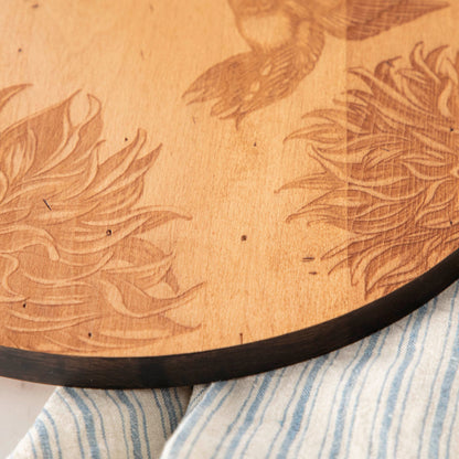 A JK Adams Hummingbird Maple Artisan Round Charcuterie Board.
