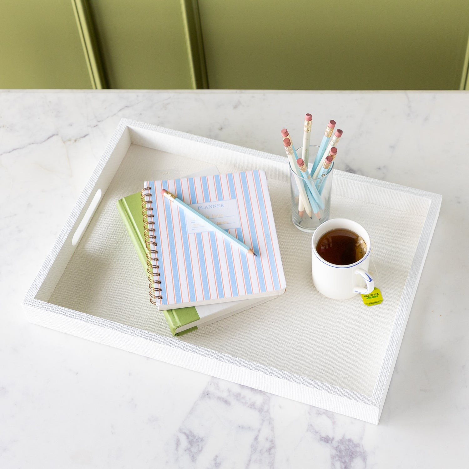 Silk Linen St. Tropez Decorative Tray with a book, planner, cup of tea and cup of pencils atop.