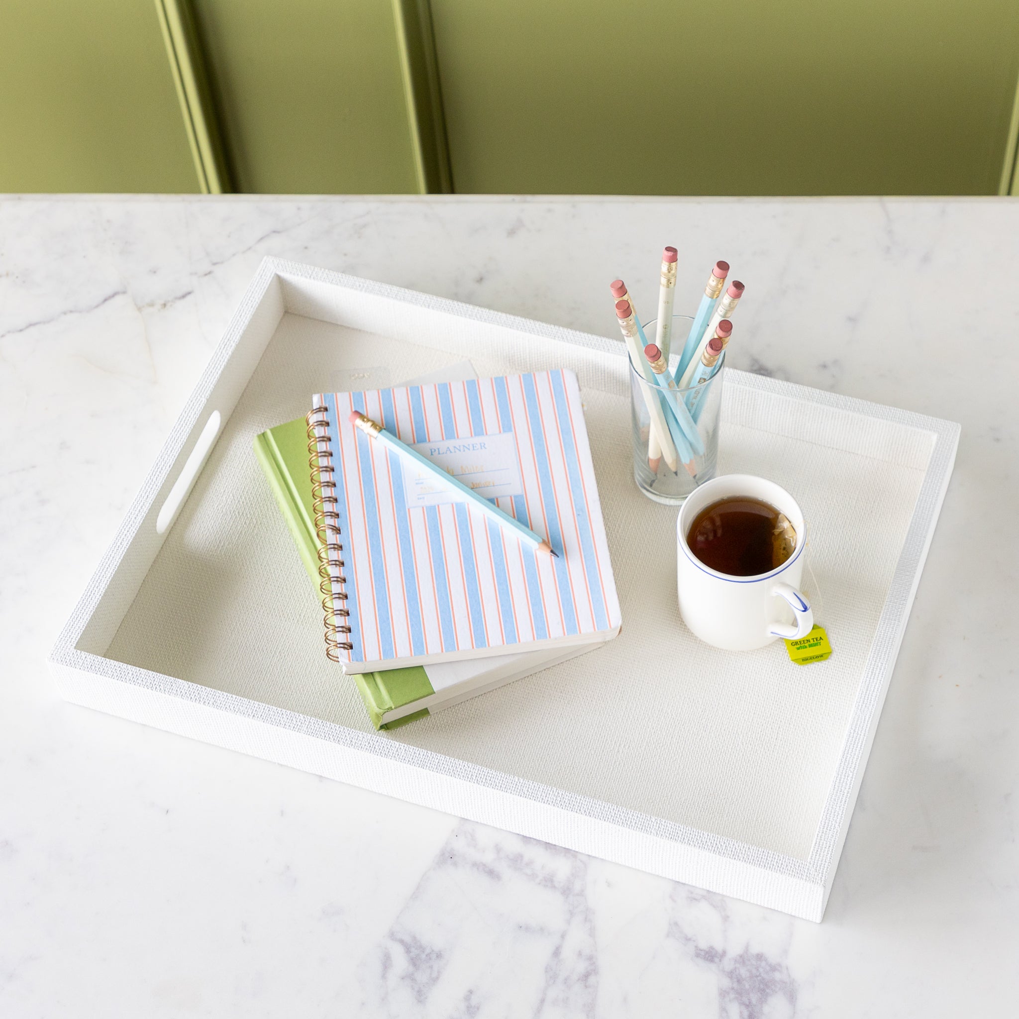 Silk Linen St. Tropez Decorative Tray with a book, planner, cup of tea and cup of pencils atop.