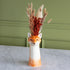 Fox shaped vase with dried flowers in it. 