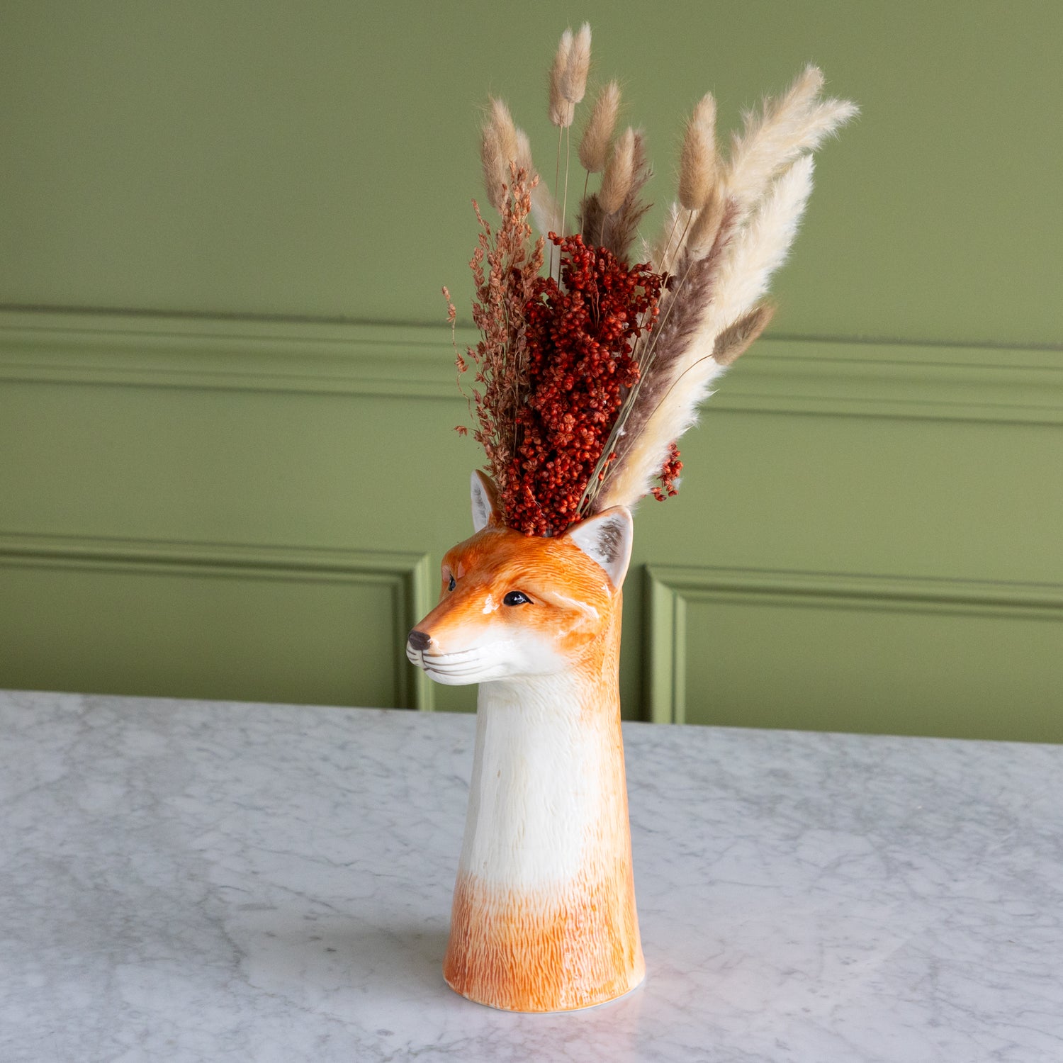Fox shaped vase with dried florals in it. 