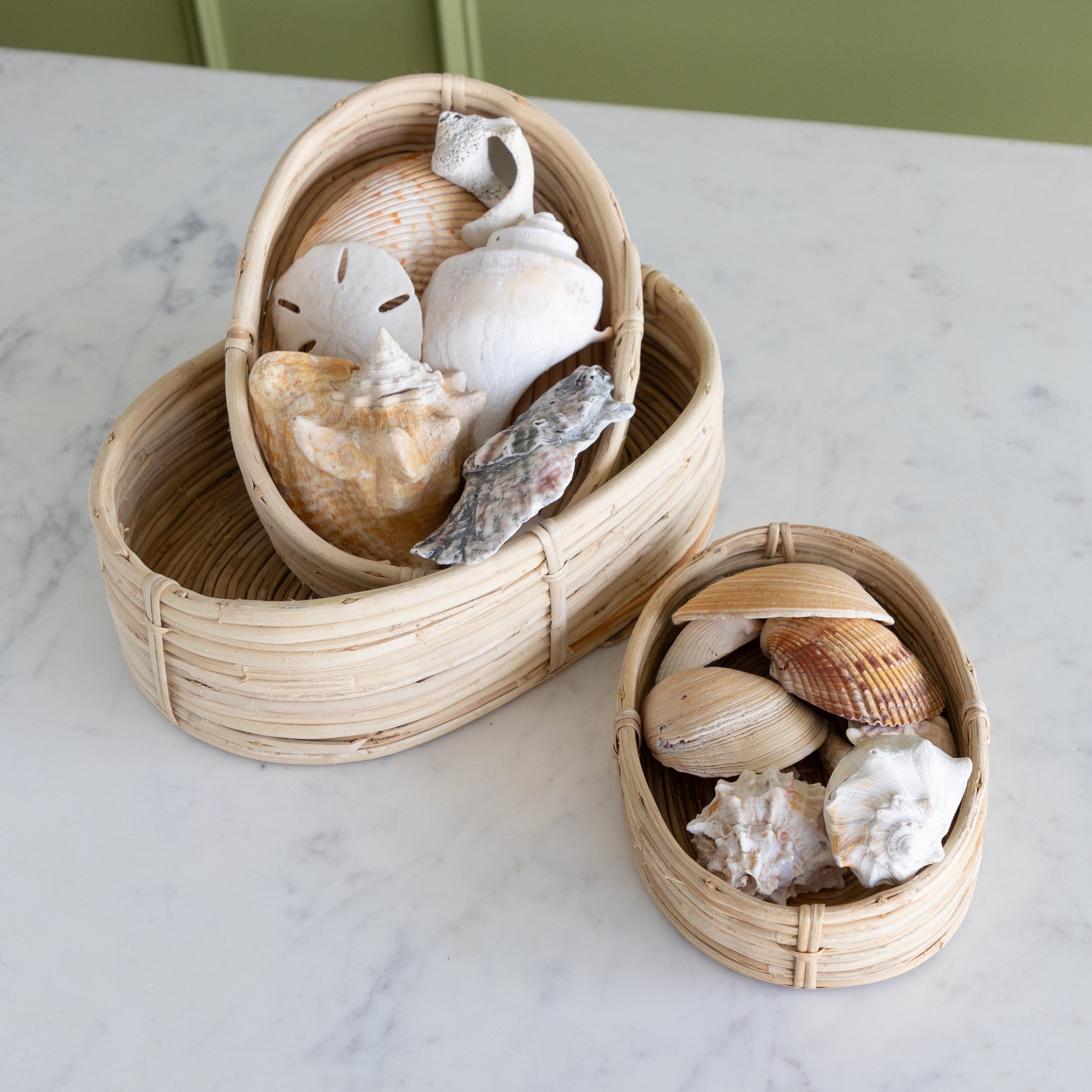 Woven baskets with seashells on a marble surface