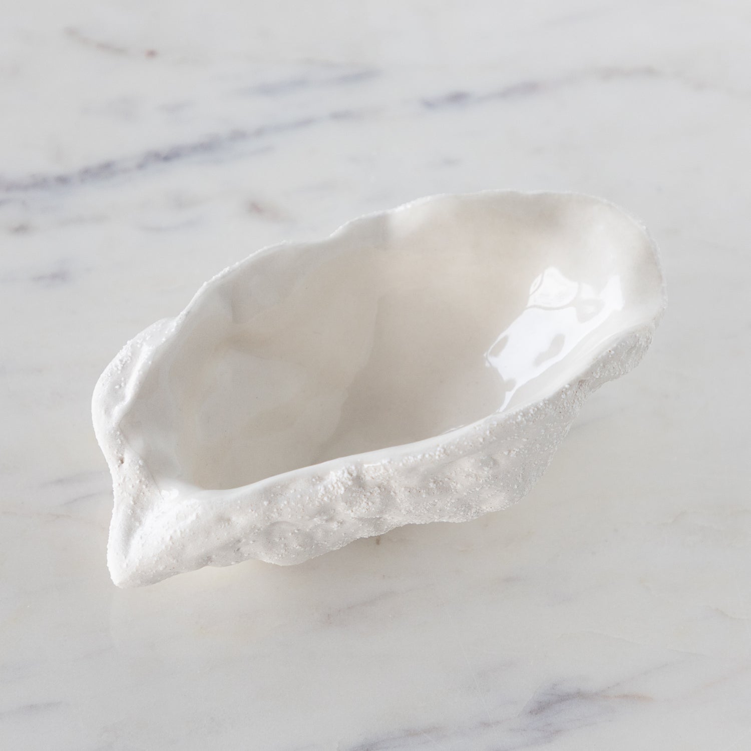 White ceramic dish on a marble surface.