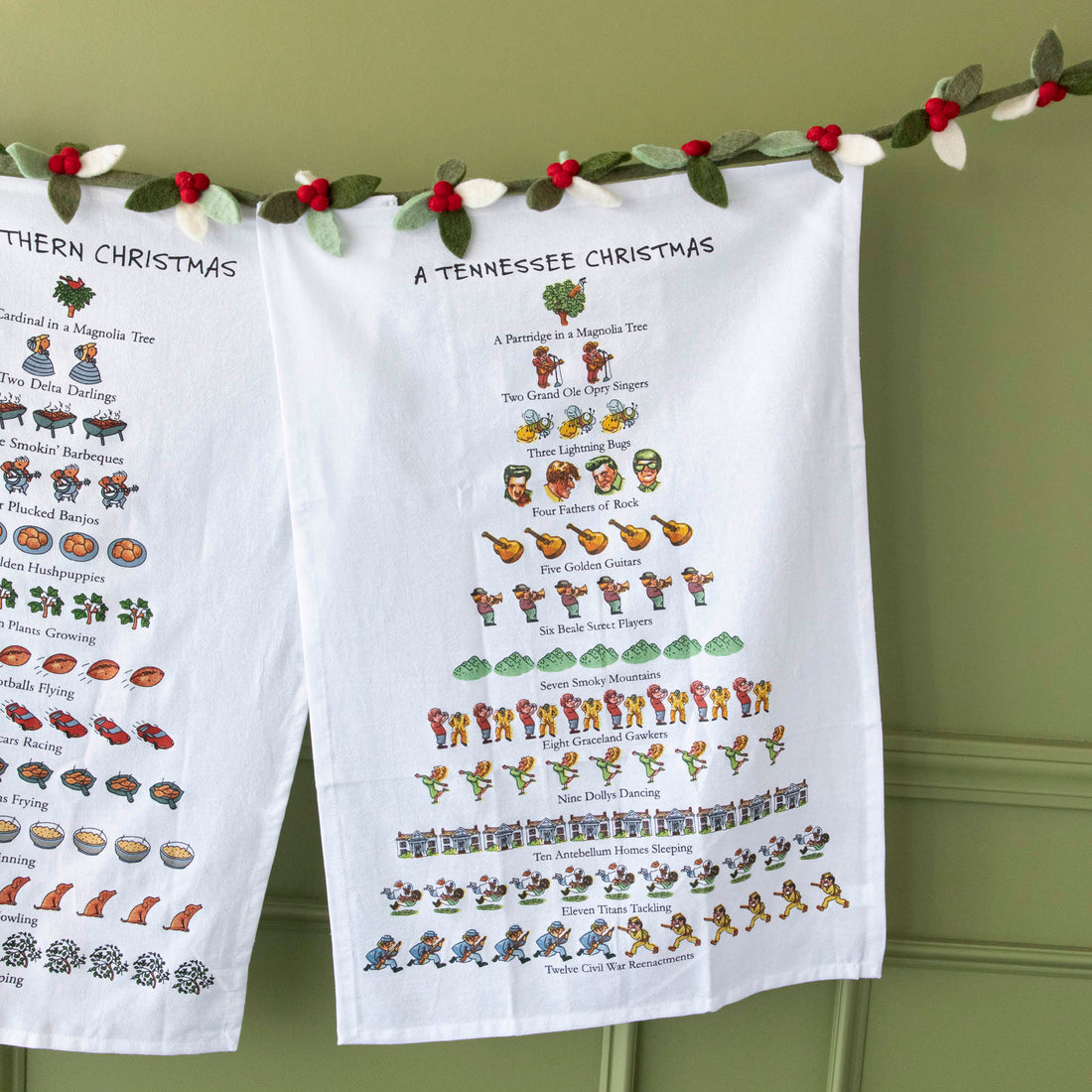 A Tennessee Christmas Tea Towel hung on a felt berry garland.