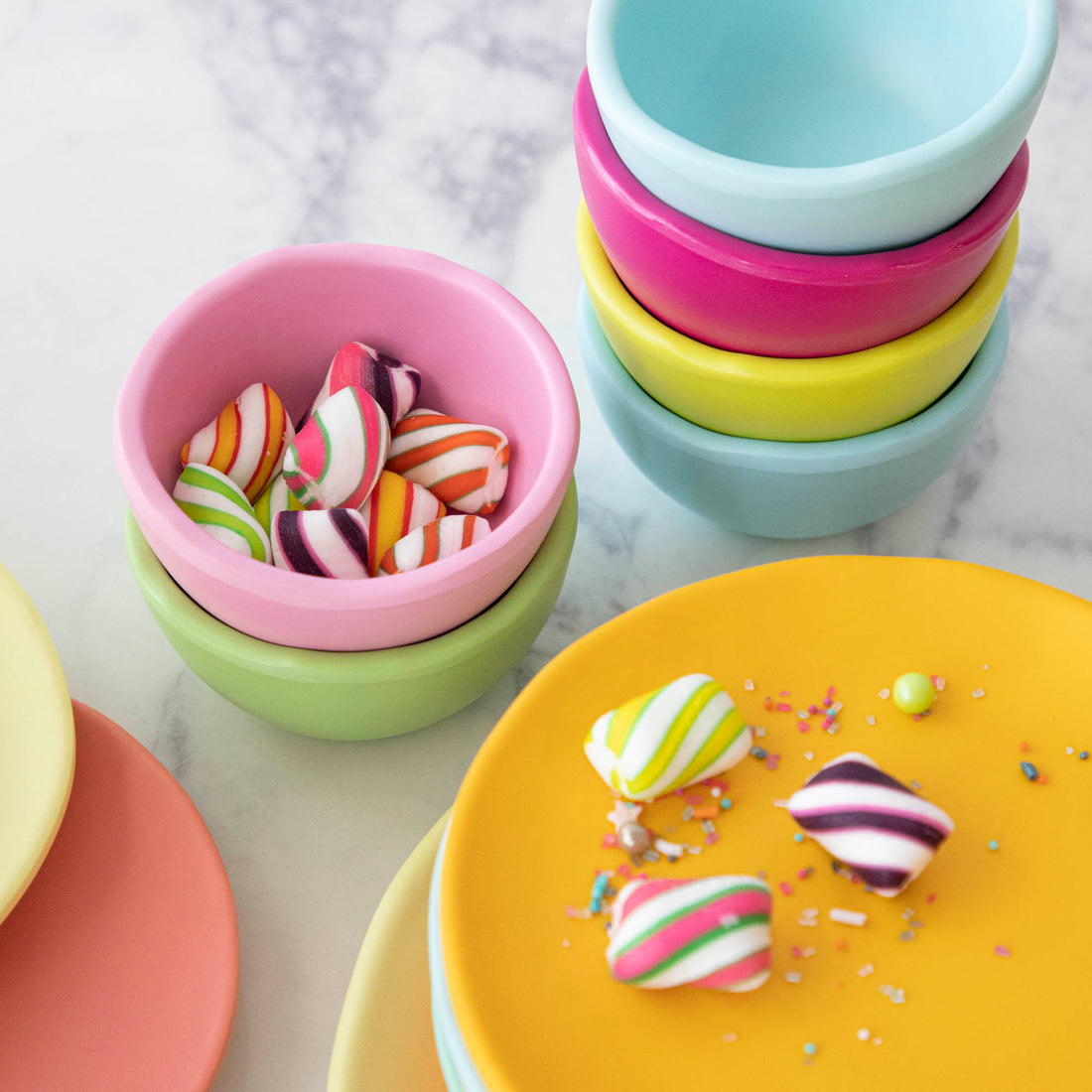 A set of colorful, dishwasher-safe Glitterville Rainbow Melamine Trinket Bowls on a table.
