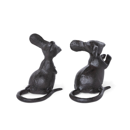 Two cast iron black mice turned around to show their tails on a white background.