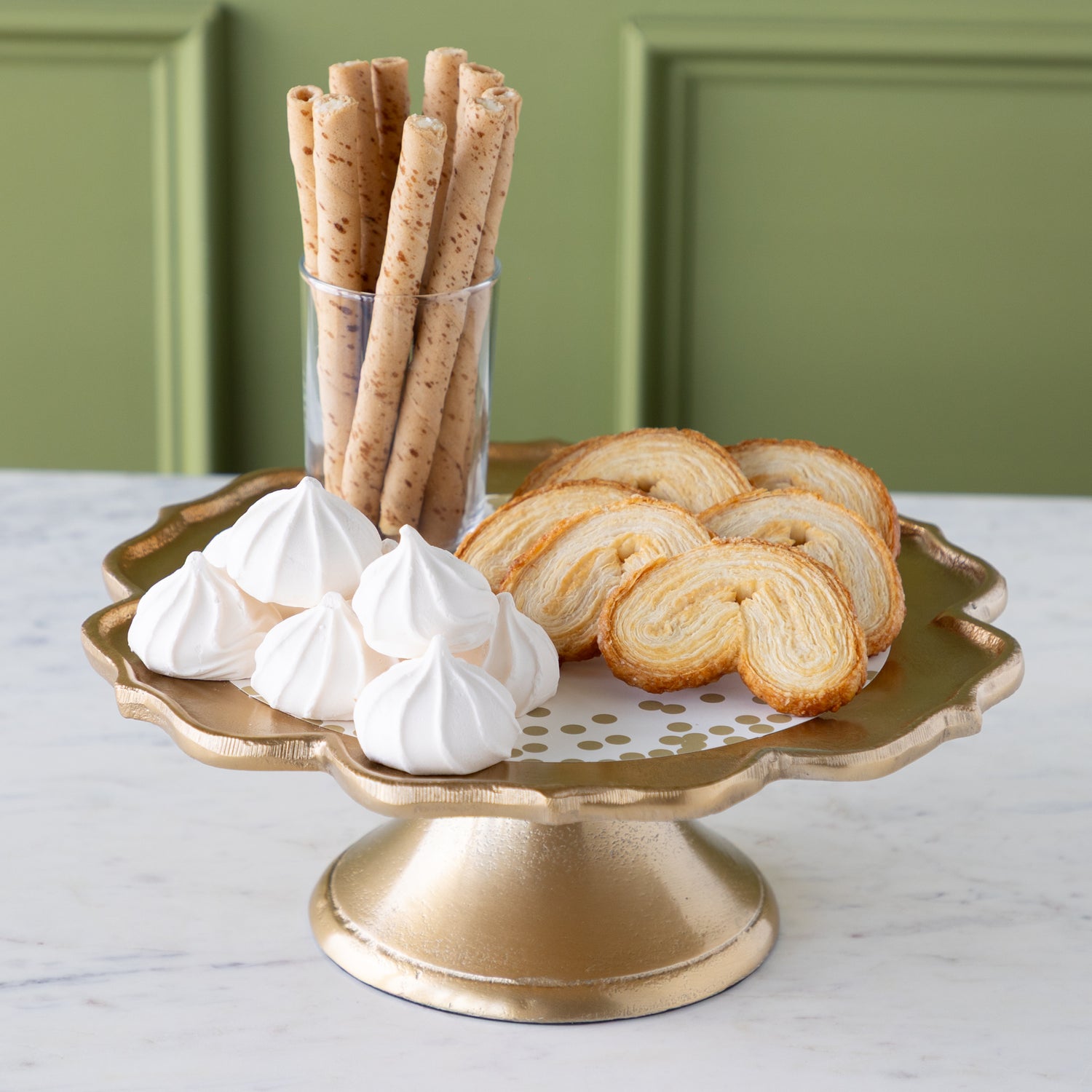 Scalloped Edge Cast Aluminum Cake Plate with the Gold Confetti Serving Paper, palmiers, meringues, and a small cup of wafers atop. 