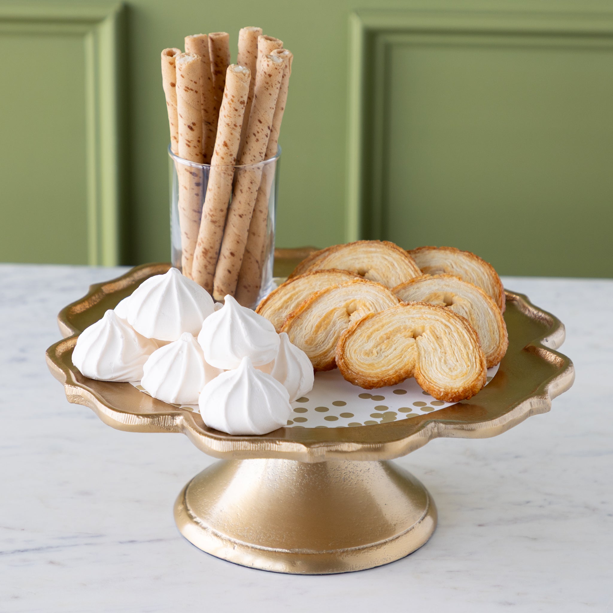 Scalloped Edge Cast Aluminum Cake Plate with the Gold Confetti Serving Paper, palmiers, meringues, and a small cup of wafers atop. 