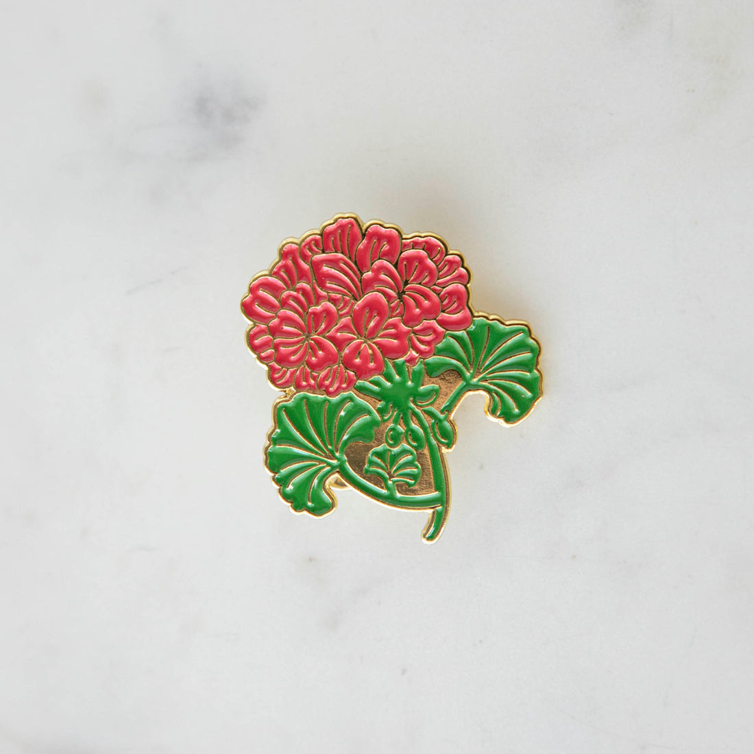 A red Geranium Enamel Pin adorned with a beautiful geranium flower from Hester &amp; Cook.