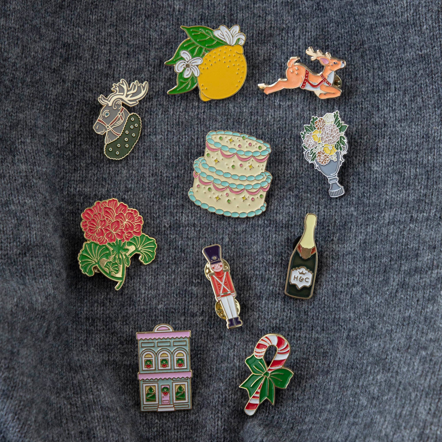 A vibrant collection of Hester &amp; Cook Geranium Enamel Pins featuring charming geranium flowers.