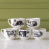 Set of six ceramic mugs with animal illustrations on a light green background.